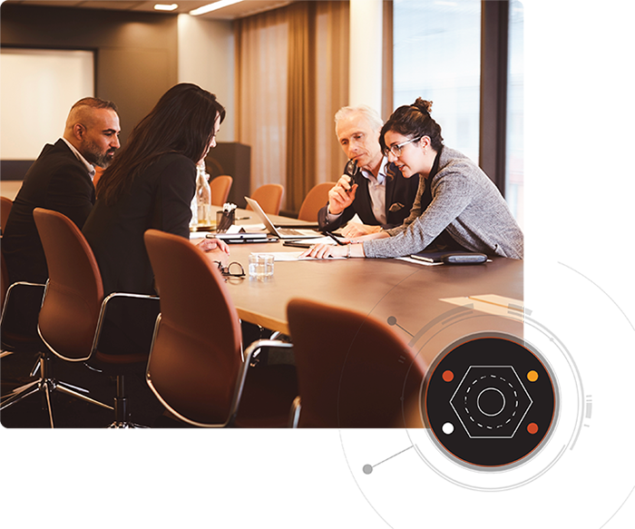 Two women and two men sit at a conference table reviewing cybersecurity retainer documents with a circle graphic overlay in the bottom right corner.